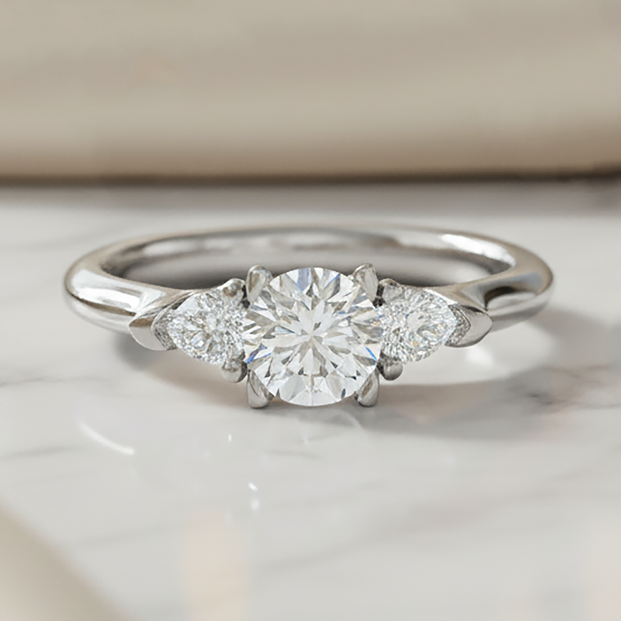 Round and Pear Three Stone Ring